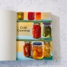 Cold Canning book open to title page depicting jars of fruits and vegetables